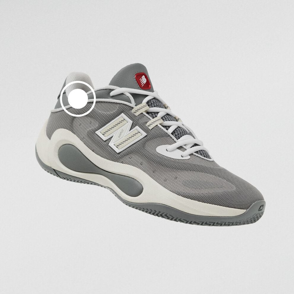 Gray New Balance athletic sneaker with a breathable mesh upper, white laces, and sculpted cushioned sole.