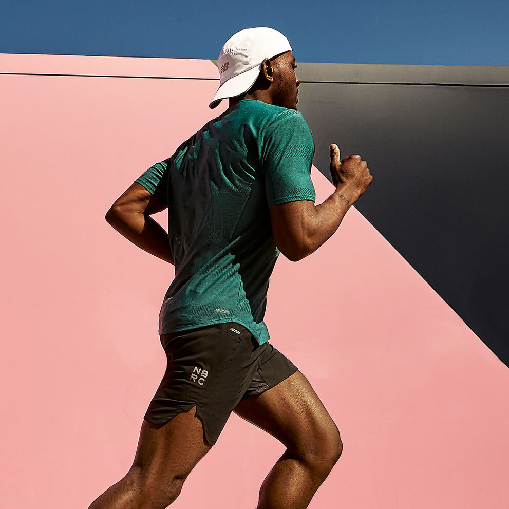 Man running profile against colorful wall