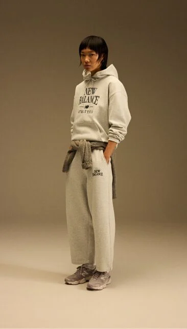 Head to toe image of a model wearing the tan and beige shoes 