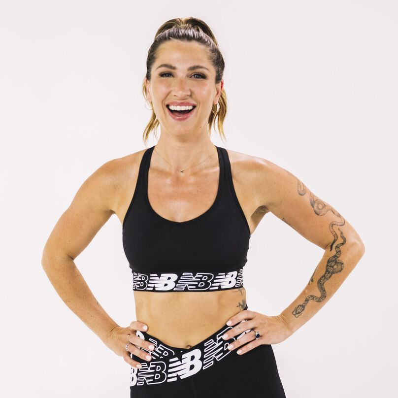 Woman wearing a black NB Pace Bra facing the camera in a studio environment.