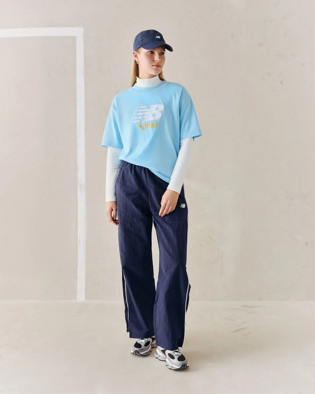 A person wearing a blue soccer graphic tee.