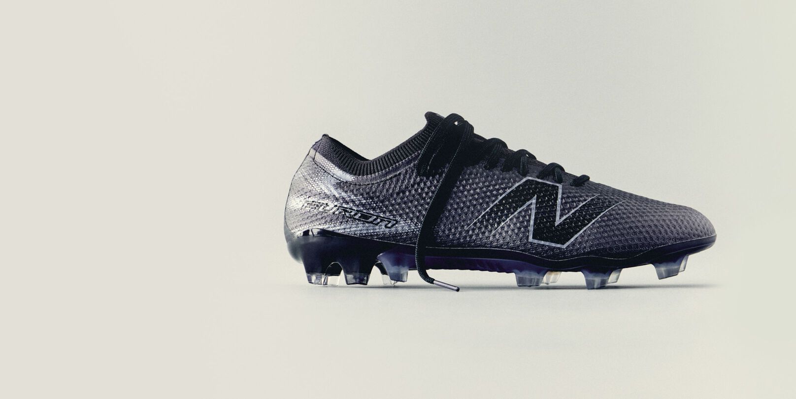 A triple black furon boot on a tan background.