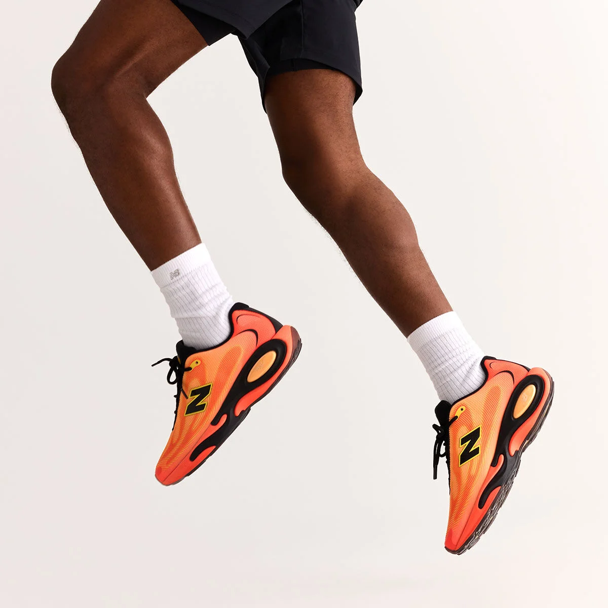 A hip down image of a person jumping in the air.