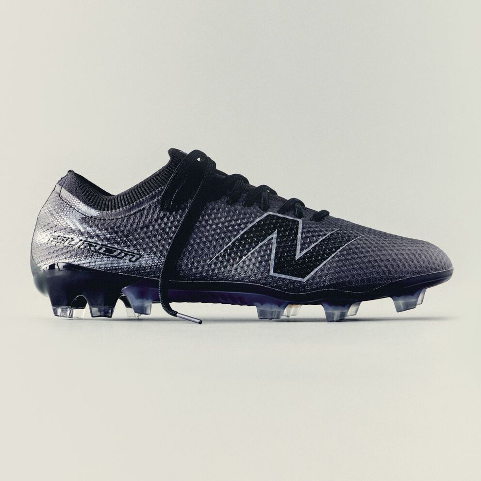 A triple black furon boot on a tan background.