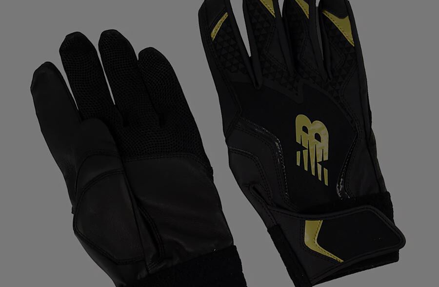 A pair of black and yellow baseball gloves. 