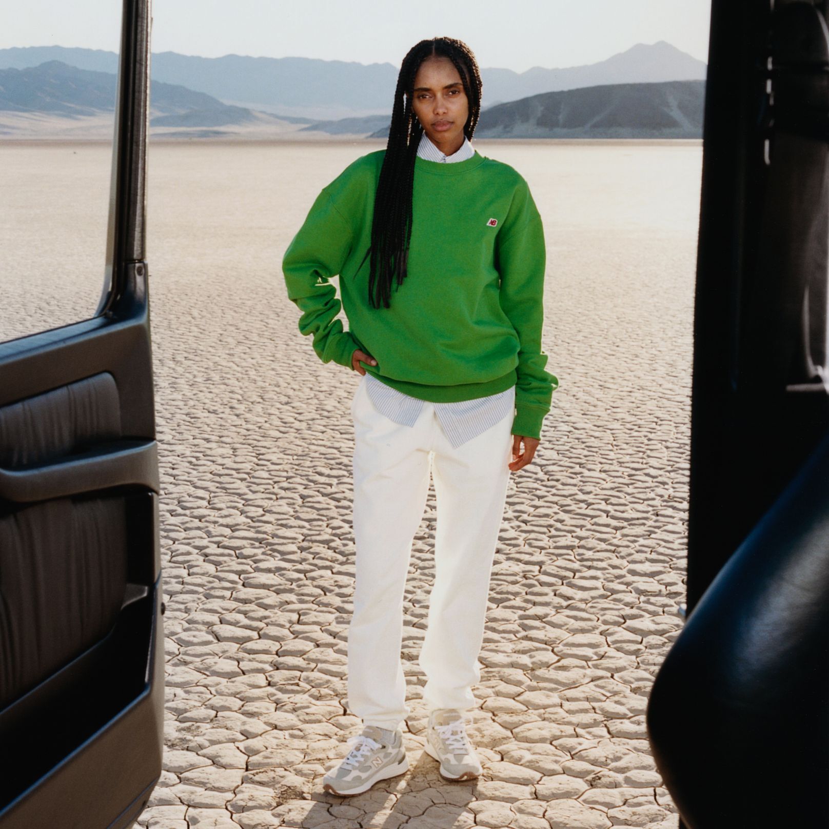 A woman standing in a desert environment. 