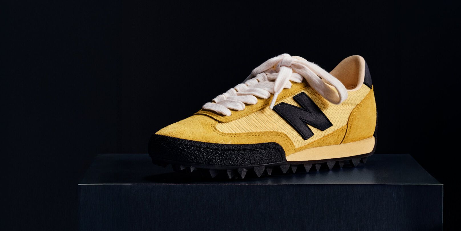  Single yellow sneaker on a black background 