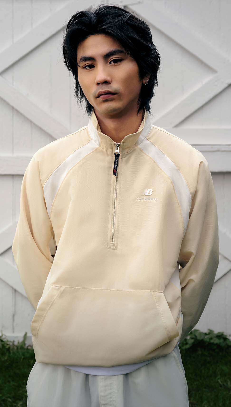 A man standing in front of white barn doors.