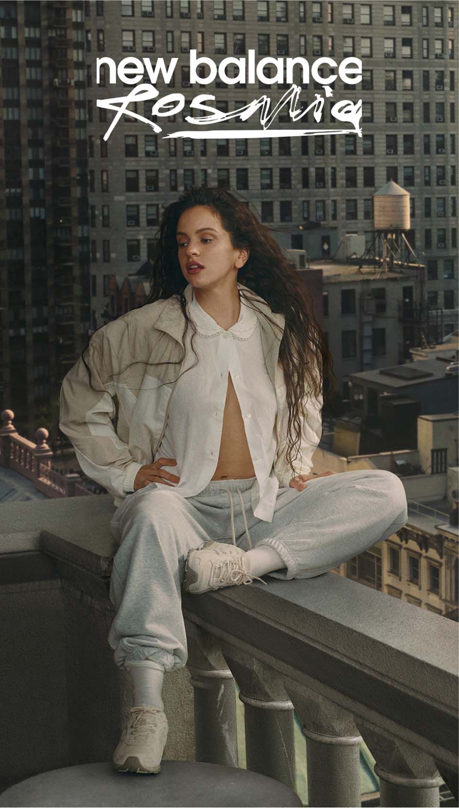 Rosalía sitting on a balcony overlooking the city. 