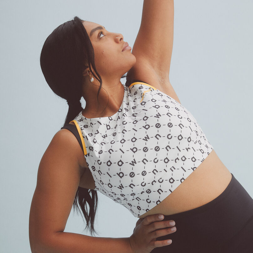 Young lady stretching with her arm in the sky.