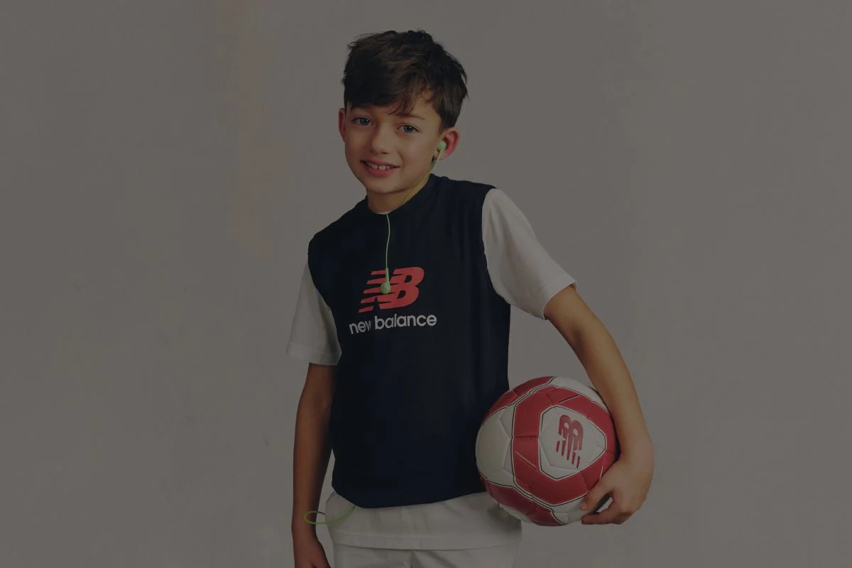 A child wearing a New Balance graphic tee.