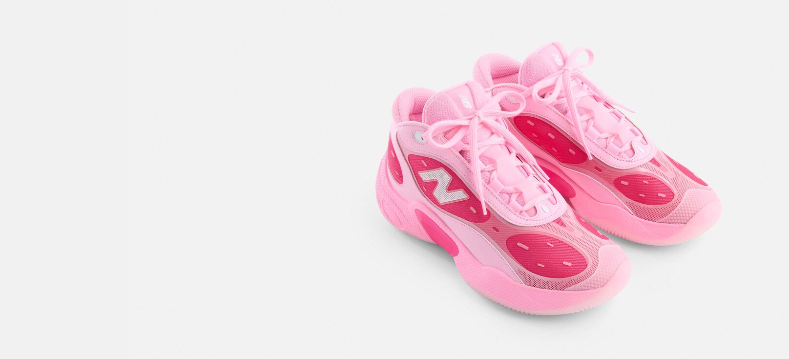 A pair of pink Fresh Foam BBV3 shoes on a grey studio background. 