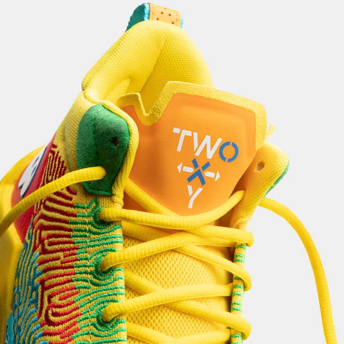 Detail photo of the yellow shoe focusing on the tongue.