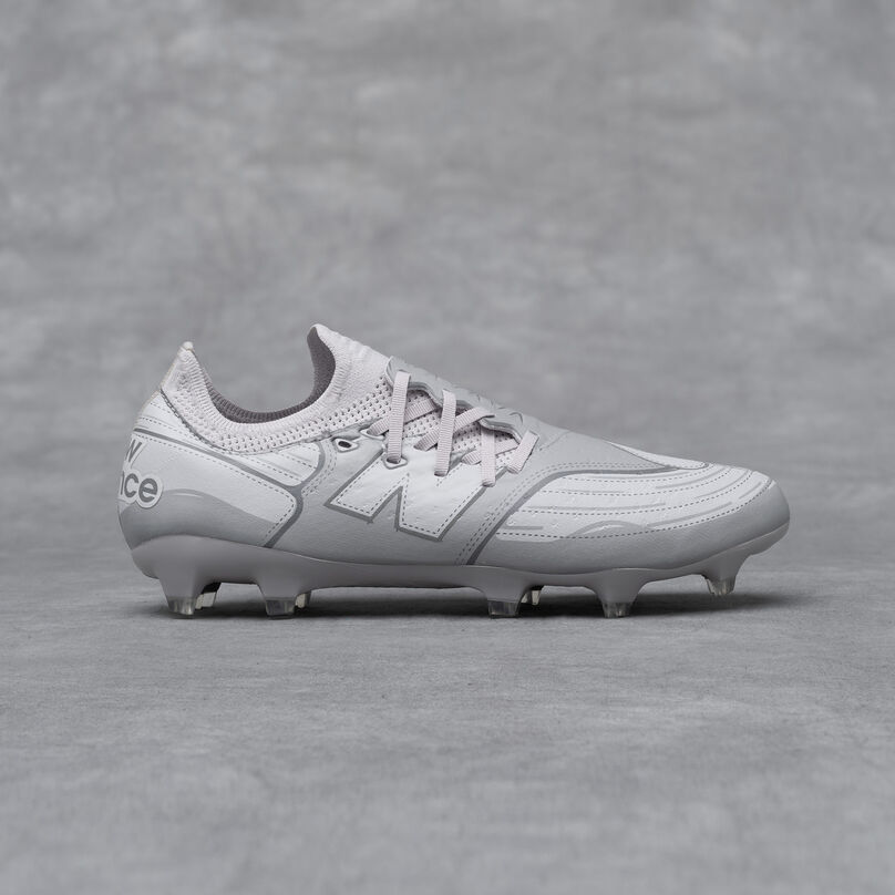 A New Balance Furon v7 football cleat on a grey studio backdrop