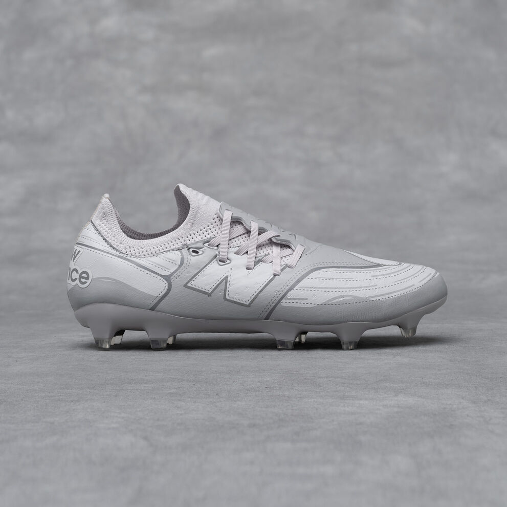 A New Balance Furon v7 football cleat on a grey studio backdrop