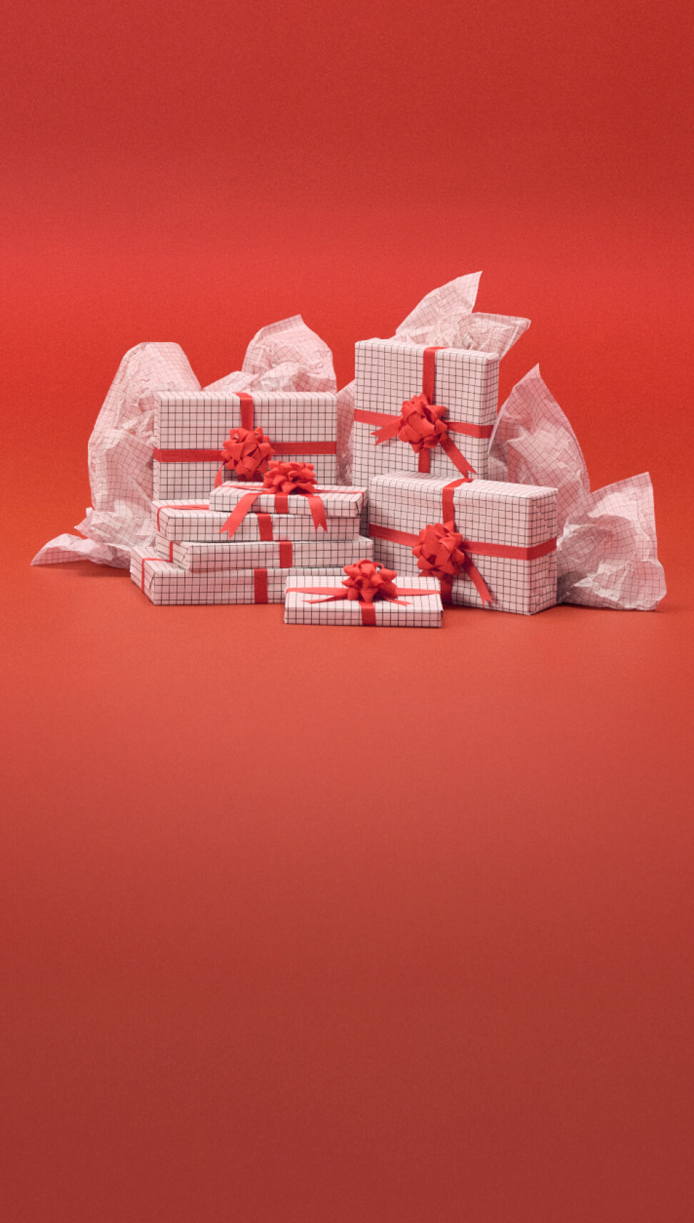 A stack of white presents wrapped in white gift paper in front of a red background.