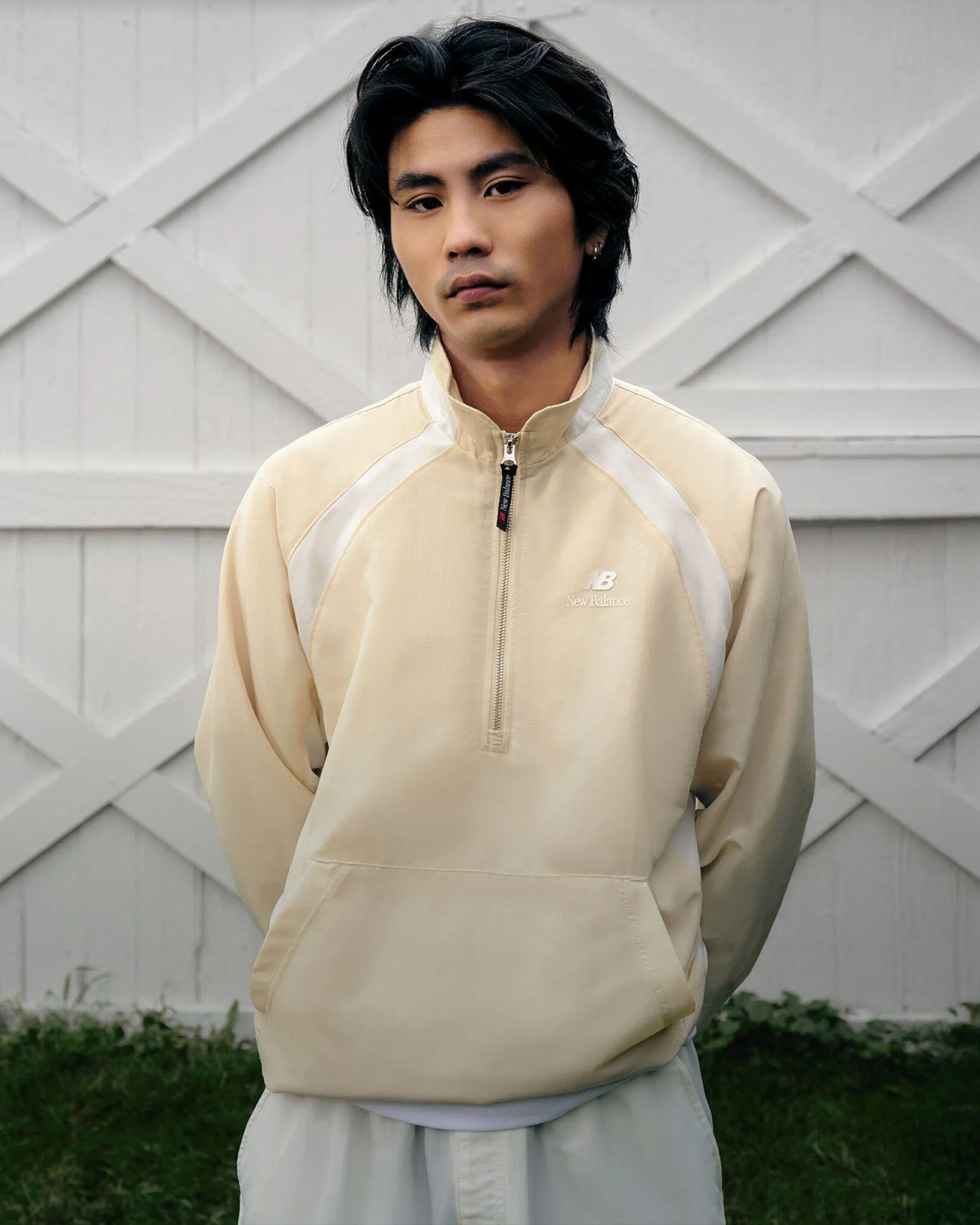A man standing in front of white barn doors.