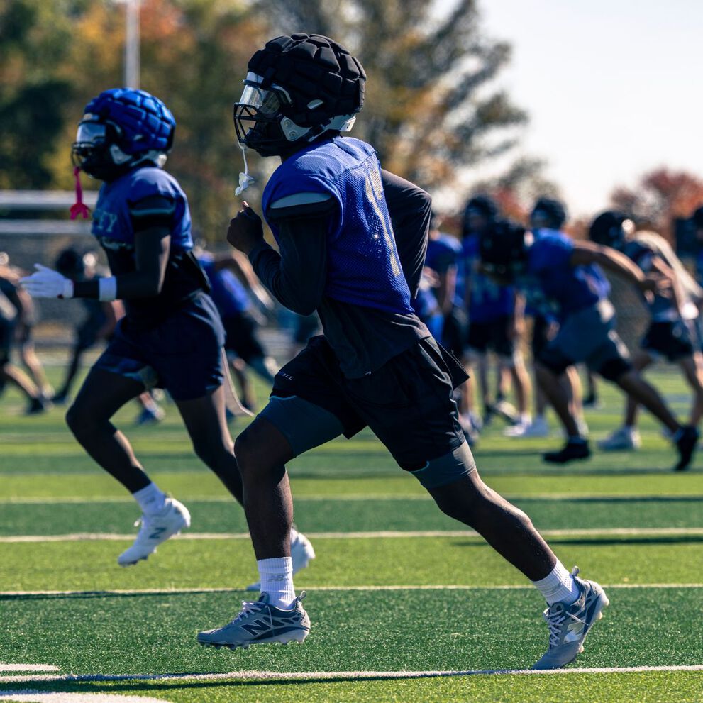 High school football players on a field.