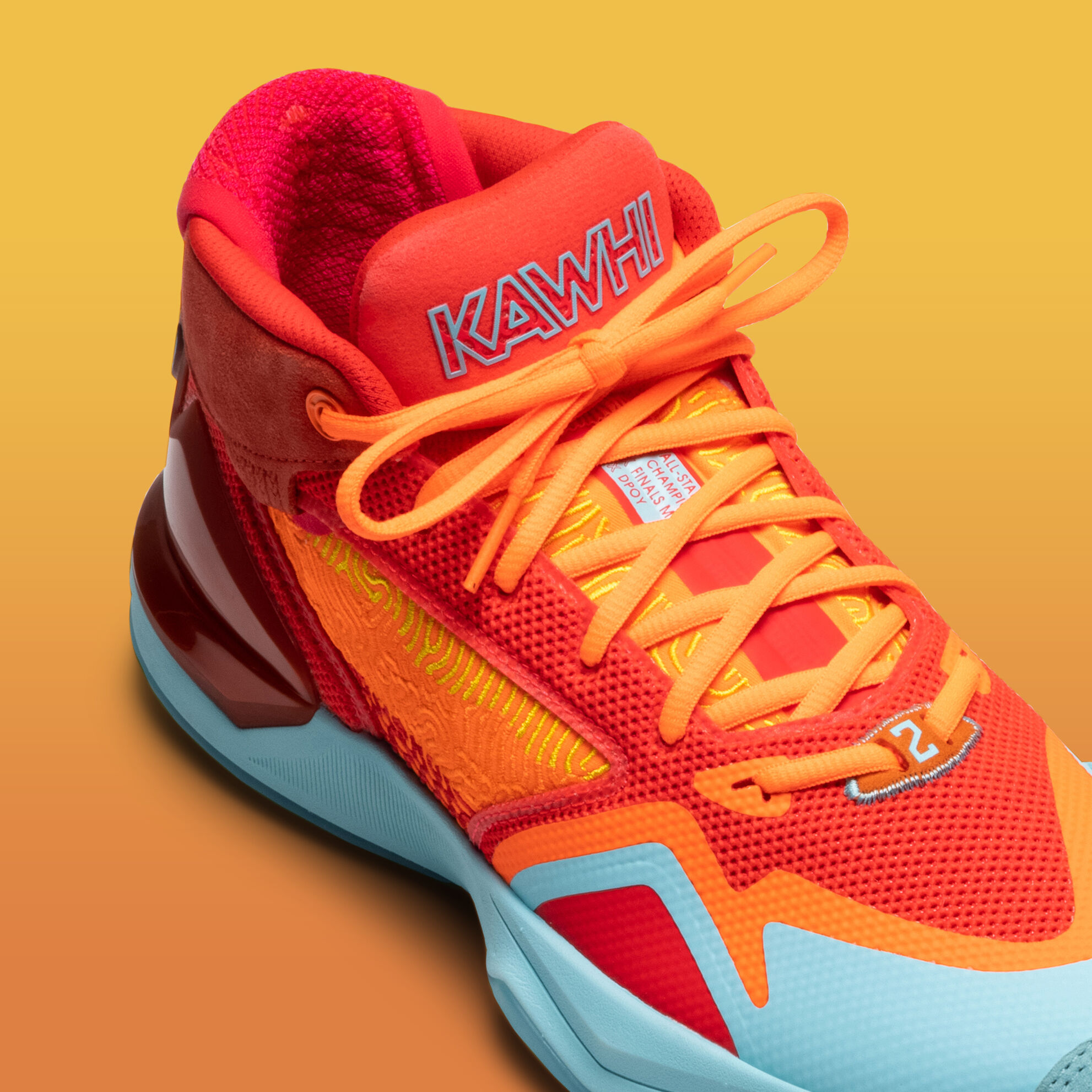 Orange and blue basketball shoe closeup of the tongue.