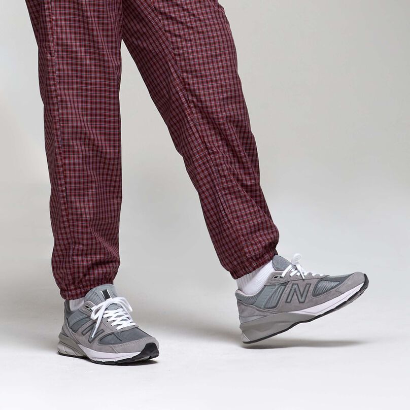 Grey 990 women’s sneaker styled with plaid pants