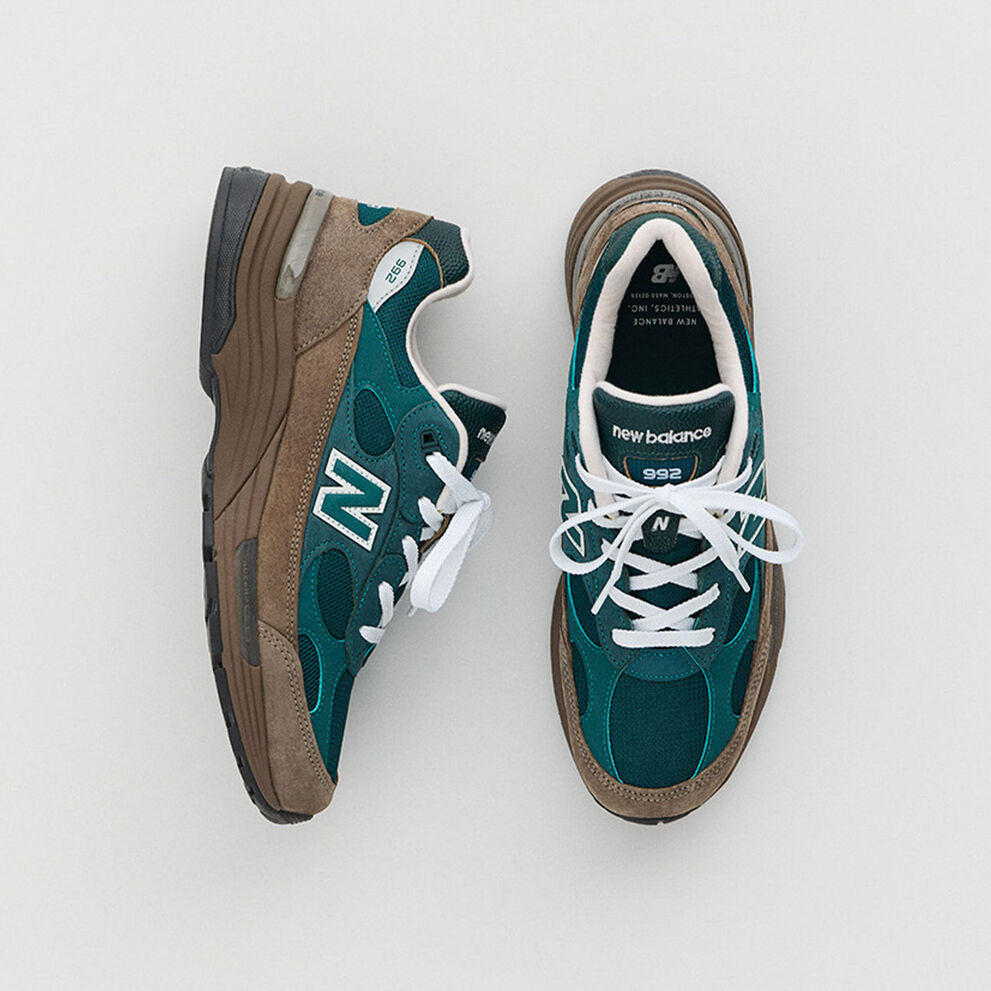 Two green and brown shoes on a white background