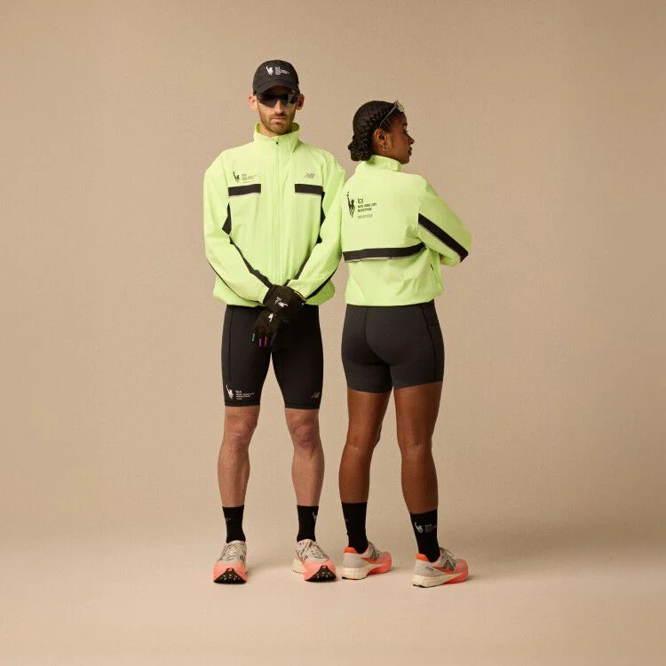 A man and woman wearing neon yellow jacket and running apparel in front of a beige background.
