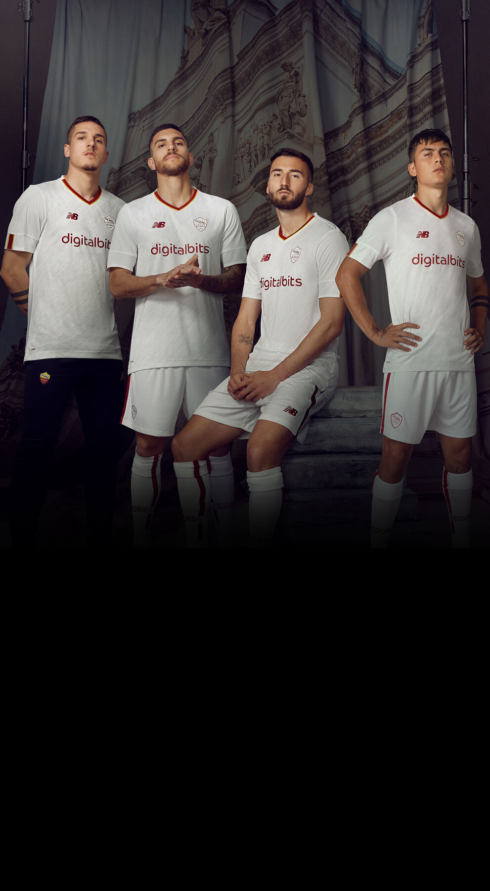 Four soccer athletes standing next to each other in white uniforms.    