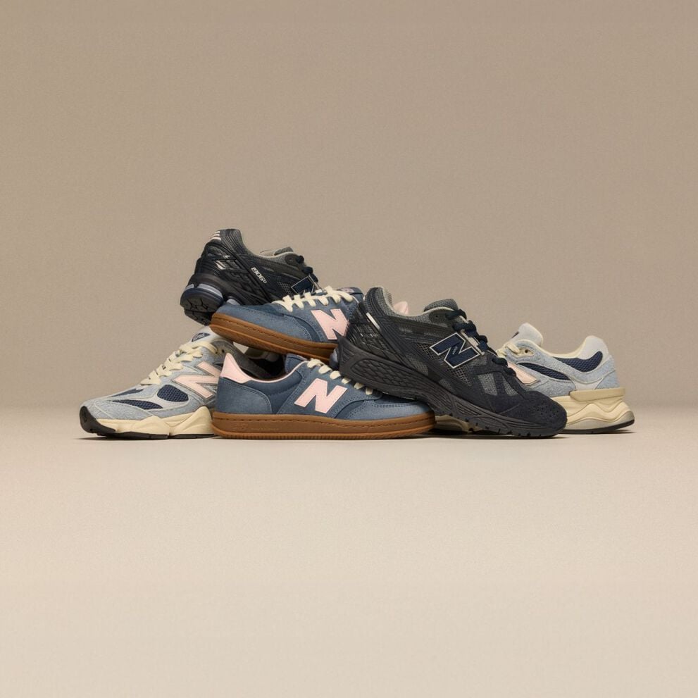 Pile of New Balance sneakers on beige background 