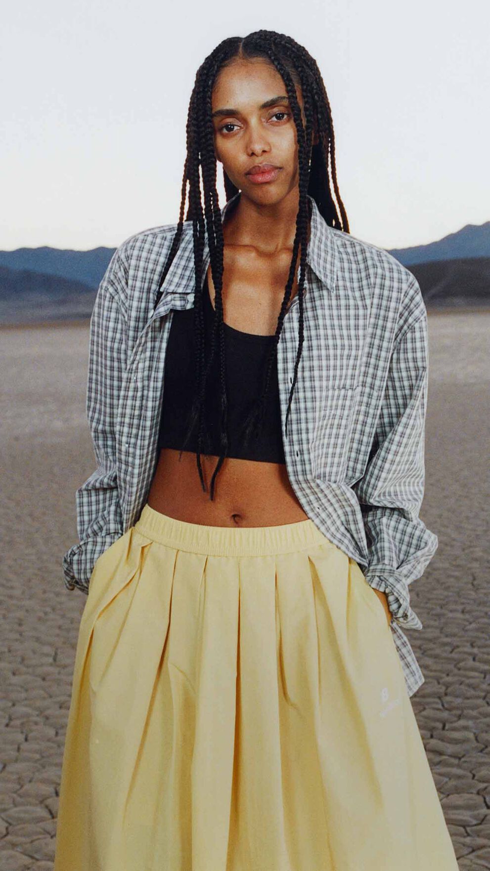 A woman standing in a desert environment.