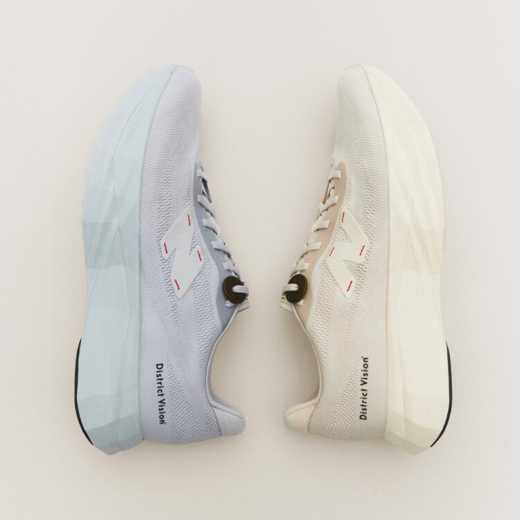 The light cream and light blue district vision shoes with a cream background.