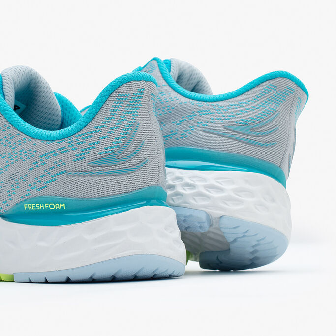 Close up view of the back of the grey and light blue running shoe.