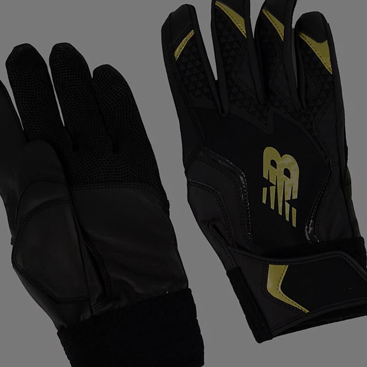 A pair of black and yellow baseball gloves. 