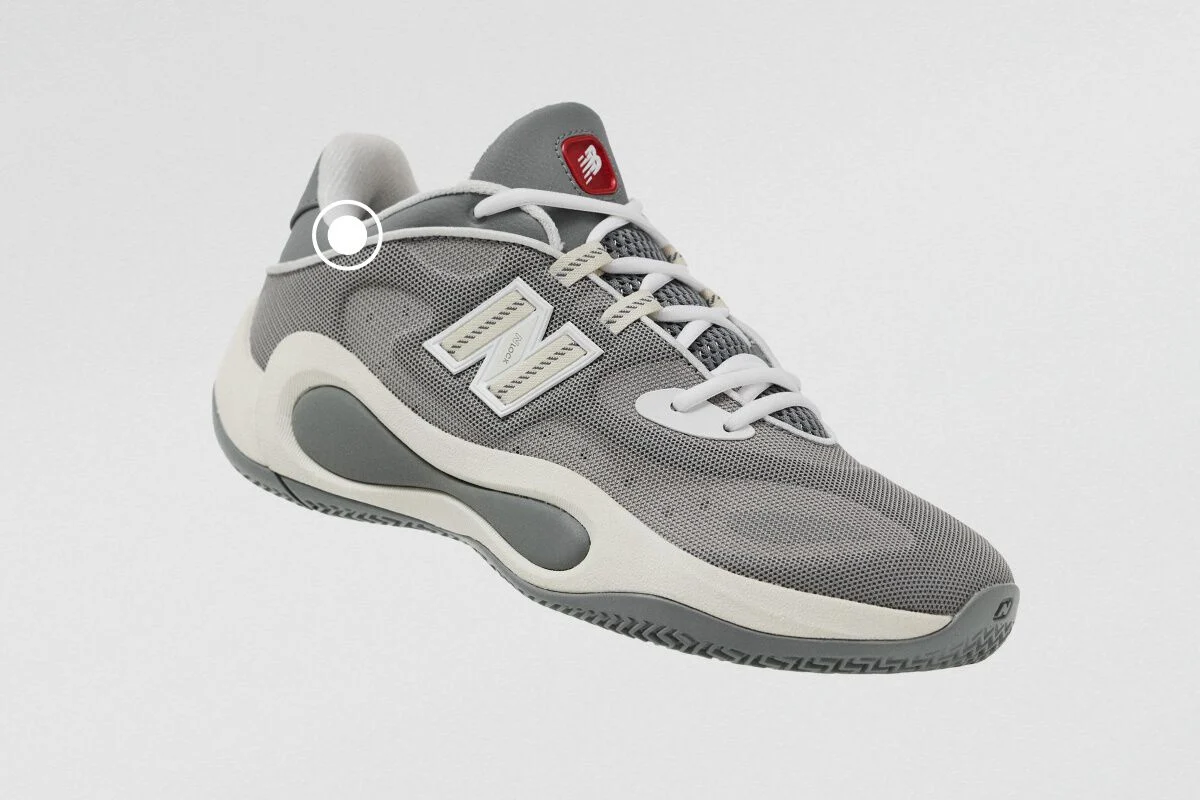 Gray New Balance athletic sneaker with a breathable mesh upper, white laces, and sculpted cushioned sole.