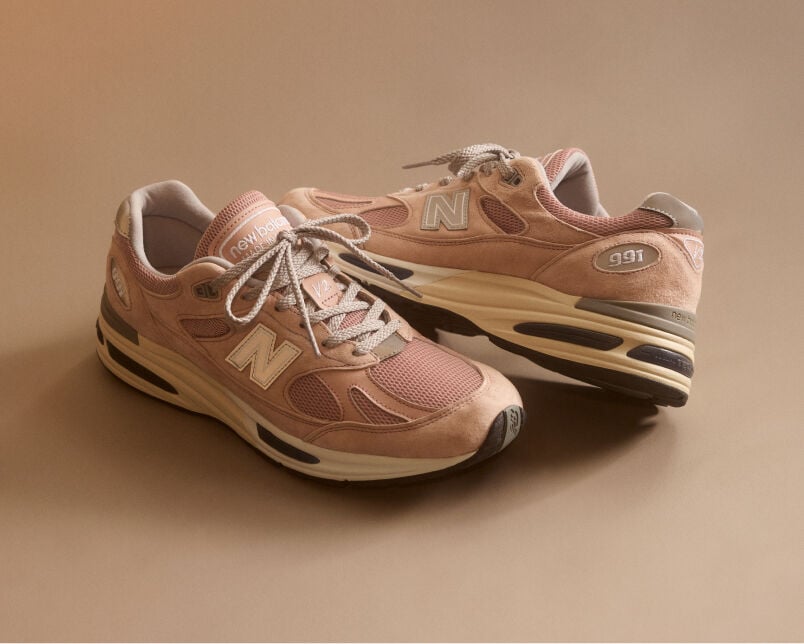 A pair of&nbsp;New Balance Made in UK sneakers in a beige studio environment.