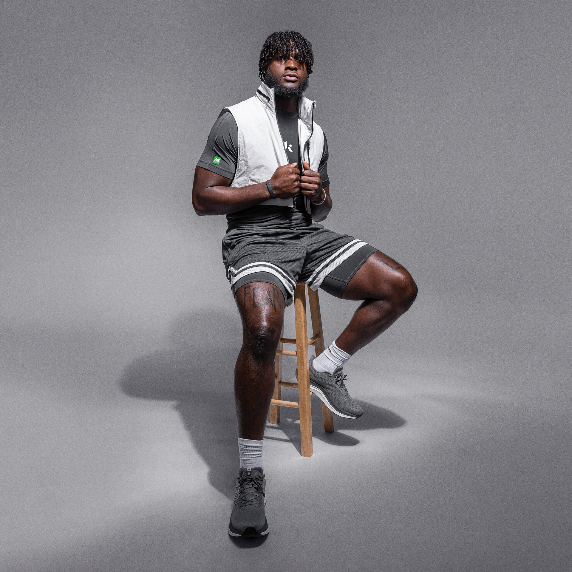 Will Anderson Jr. posed on workout bench wearing a grey sleeveless Klutch shirt and a large chain around his neck 
