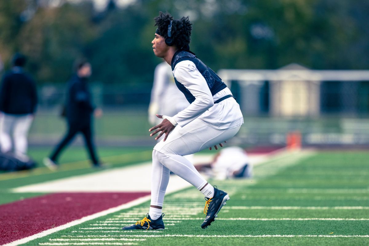 A High school football player on a field.