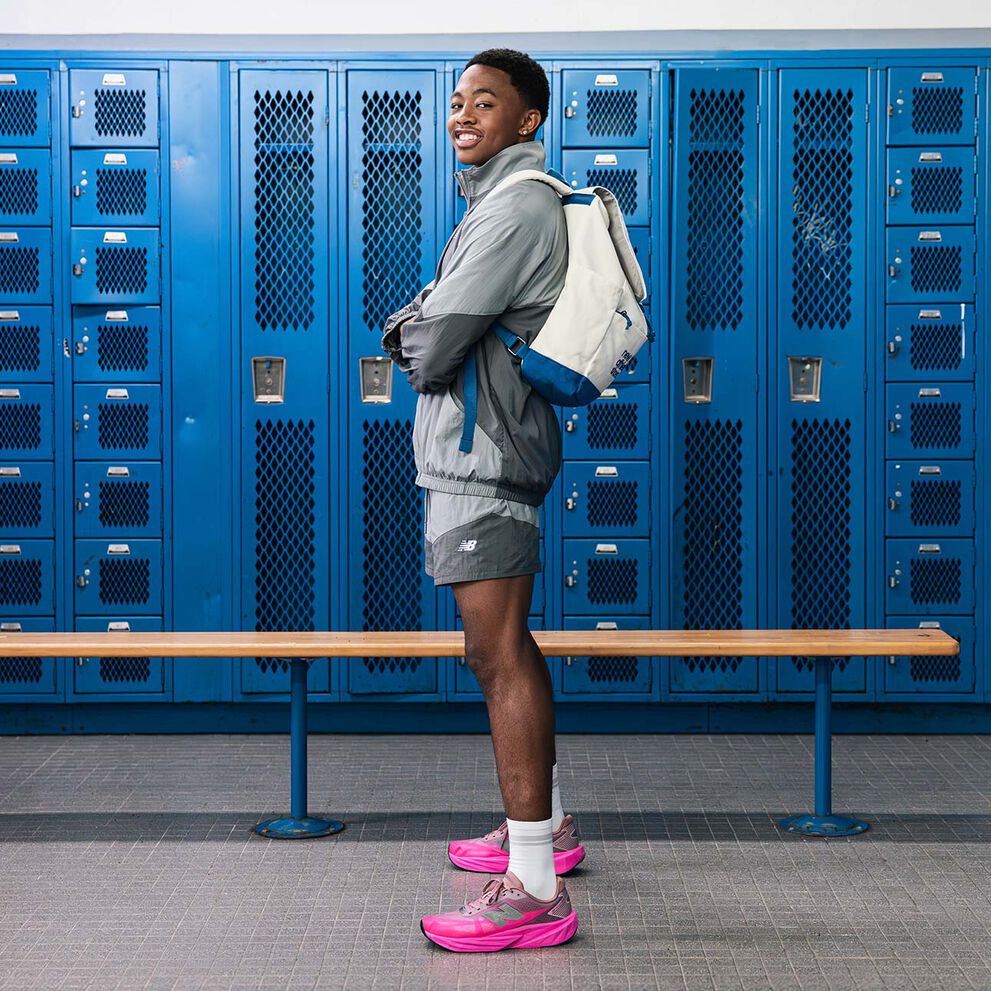 Quincy Wilson looking at the camera with NB logo overlay in the center