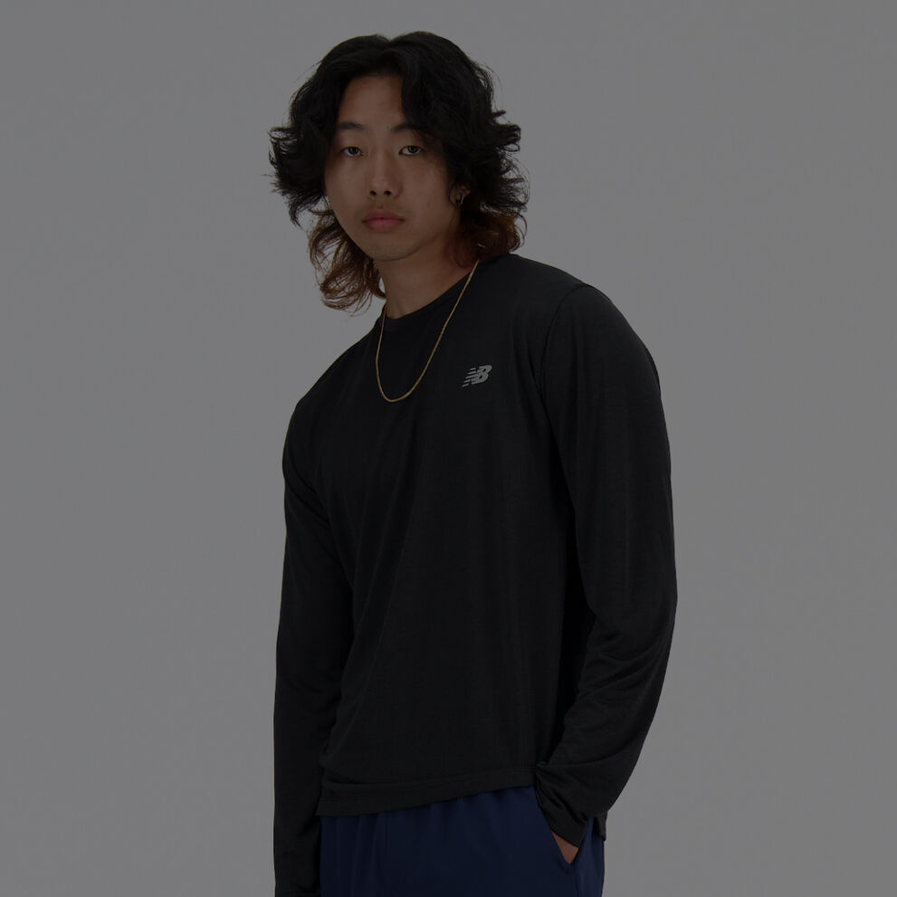 Man in long sleeve black New Balance shirt. 