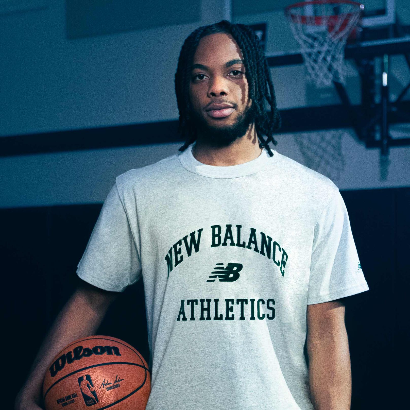 Darius Garland standing in a gym holding a basketball.