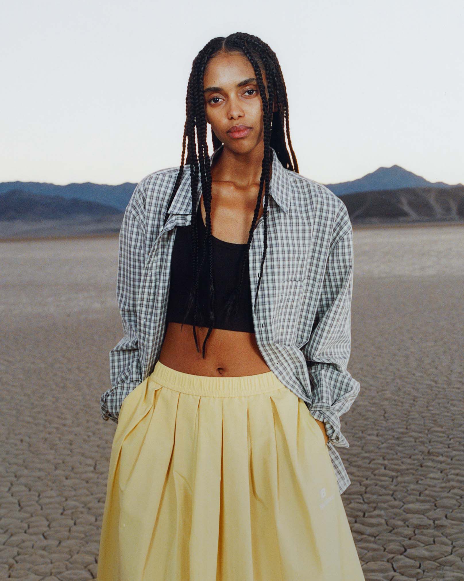 A woman standing in a desert environment.