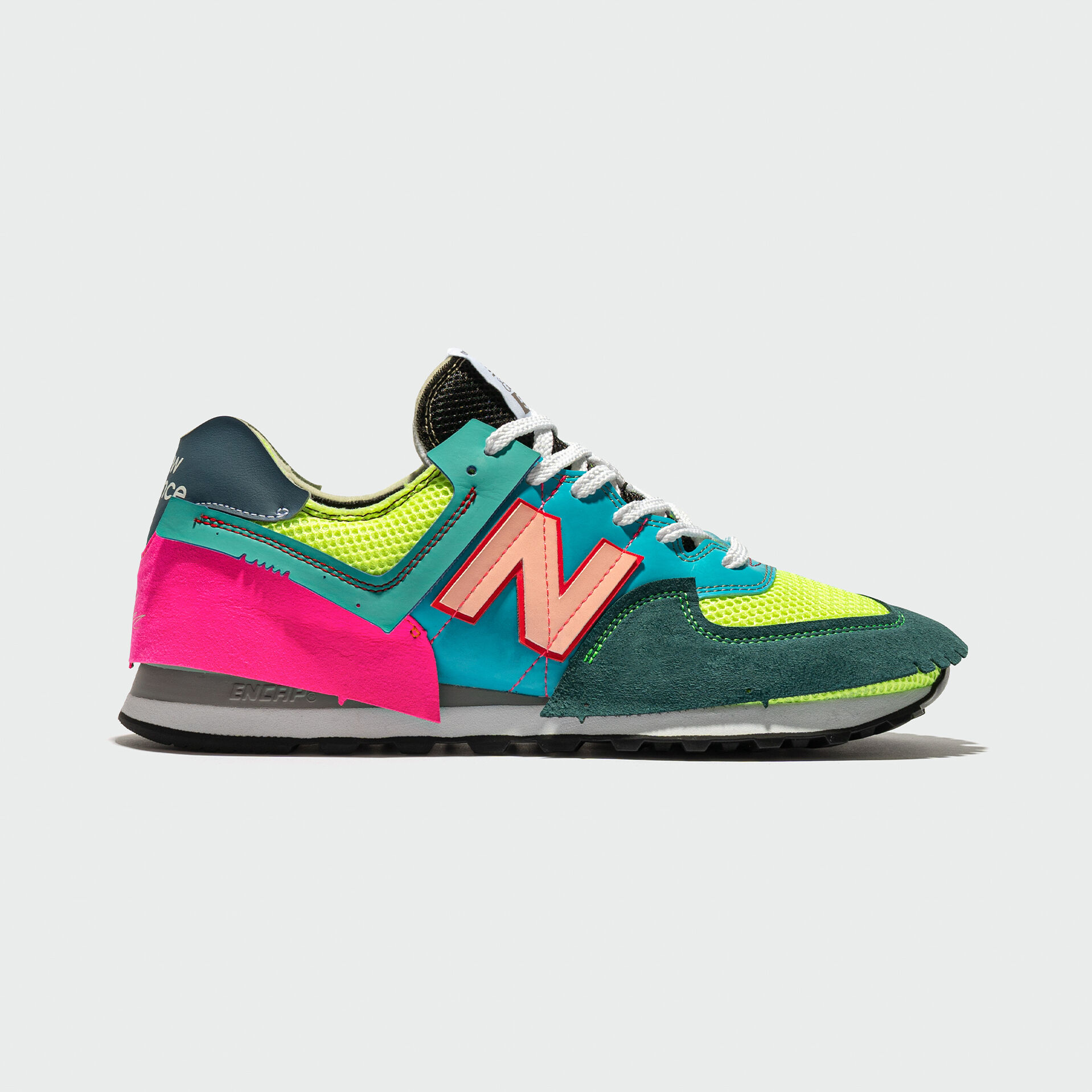 Single multi-color Jaden 574 shoe on a grey background