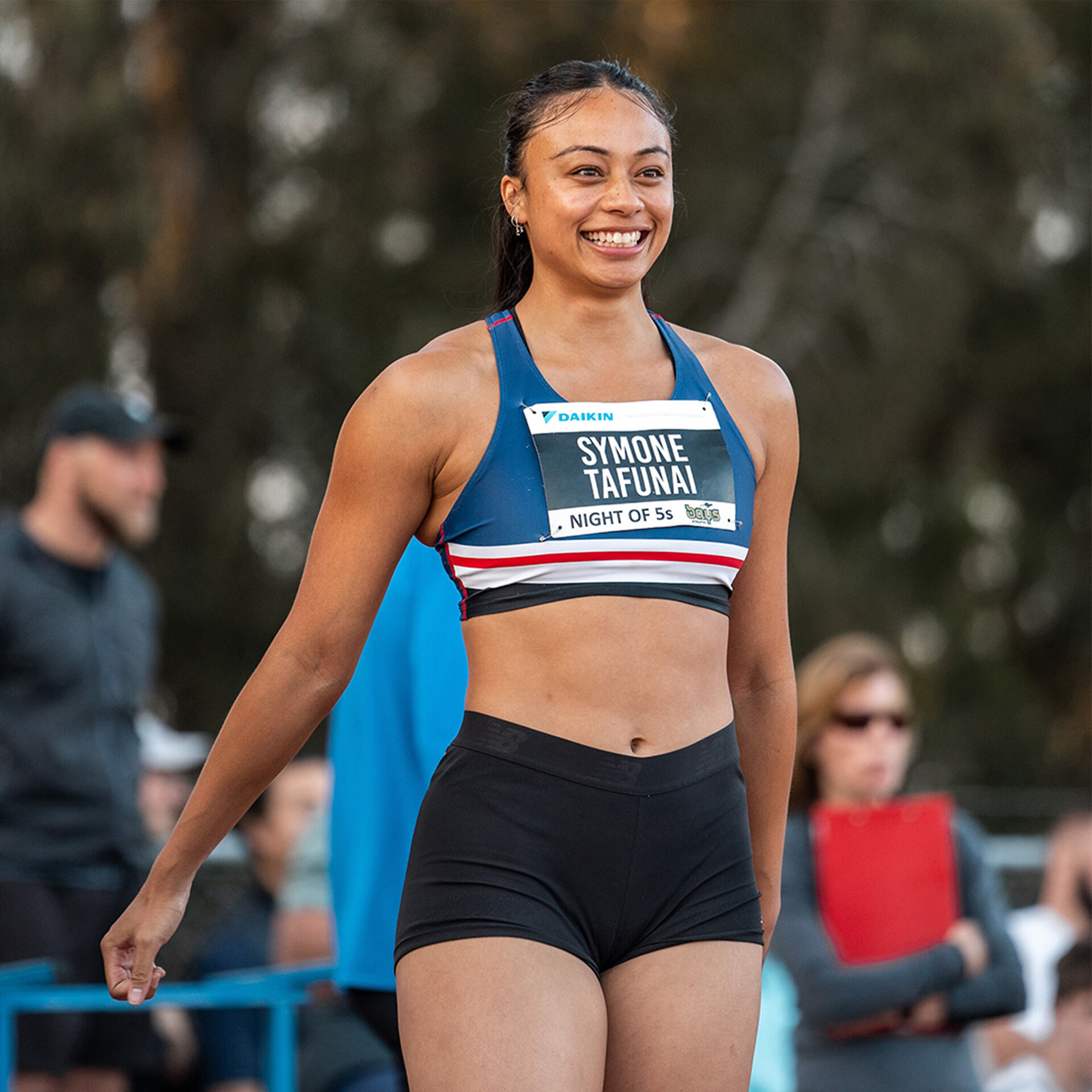 Image of Symone smiling and wearing a running bib