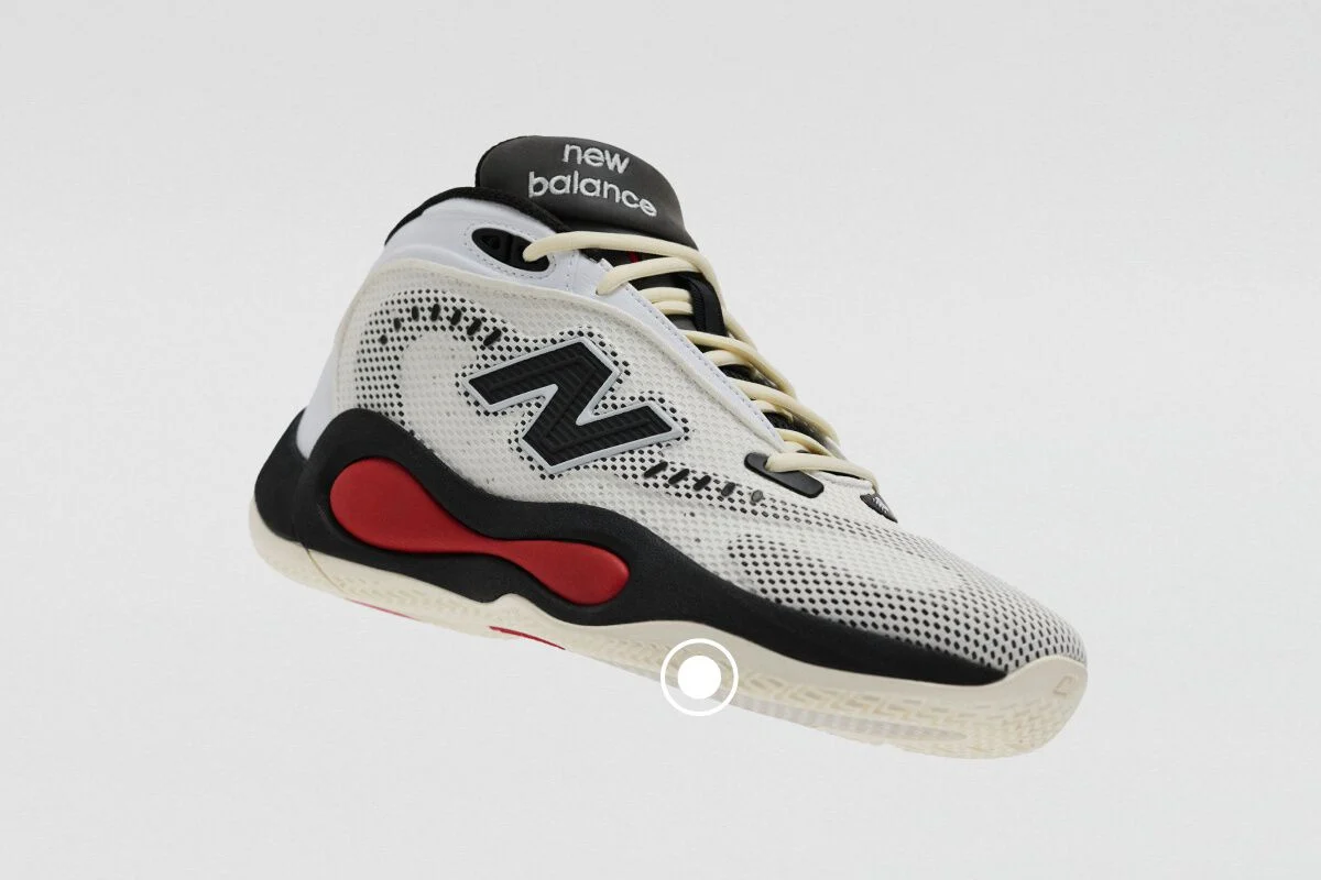 White, black, and red New Balance athletic sneaker with a knit upper, high-cut collar, and cushioned midsole.