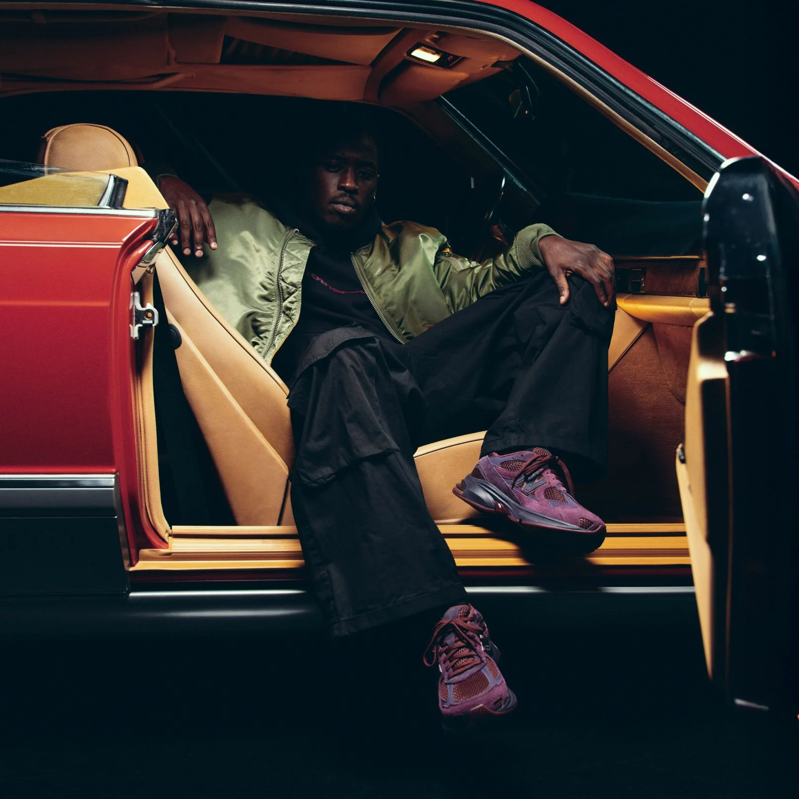 A person wearing Rich Paul ABZORBZ 2010 shoes while sitting in a car. 