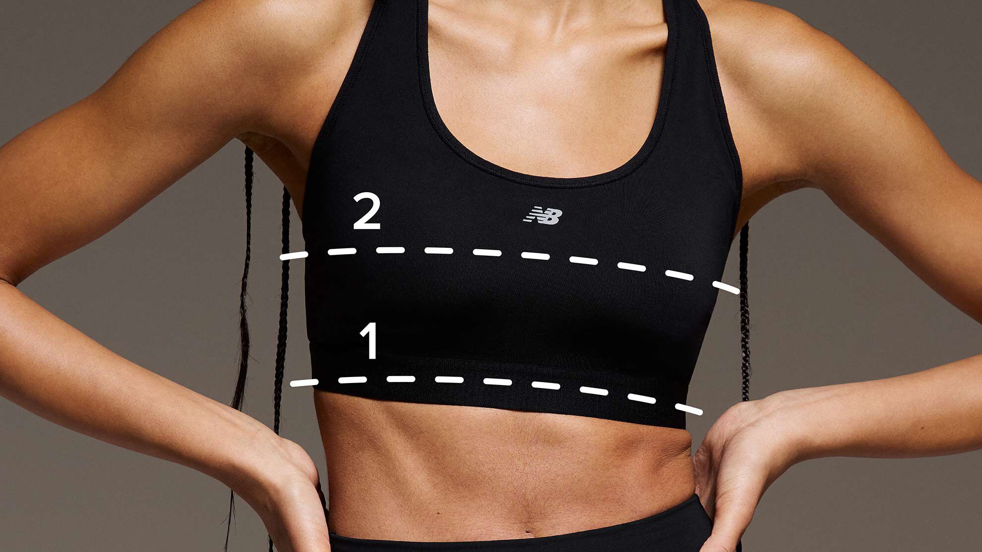 A woman wearing a sports bra with dotted lines added over the image to indicate where to measure for the right fit.
