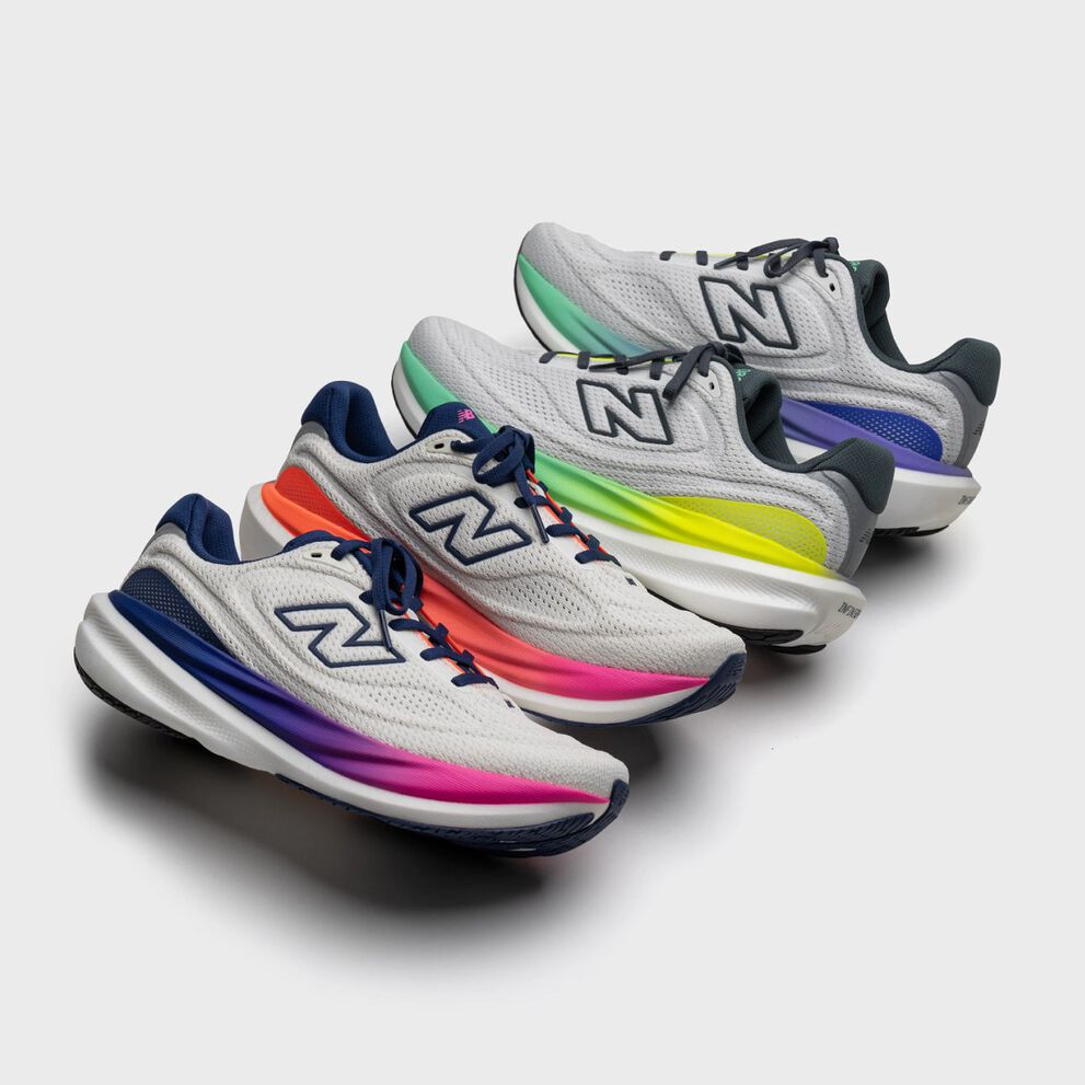 Four New Balance running shoes in light gray with white soles, each featuring a different gradient color detail: pink, orange, yellow, and green. 