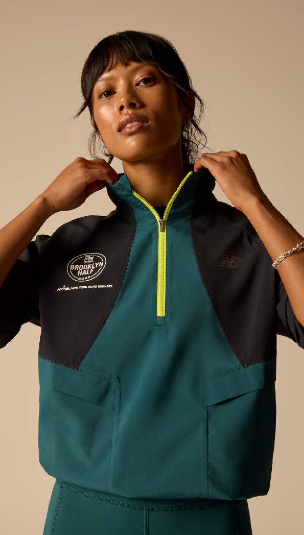 A woman wearing RBC Brooklyn NYC Half Collection apparel in studio. 