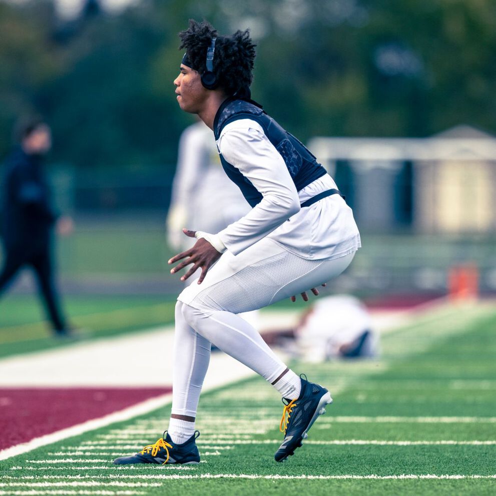 A High school football player on a field.