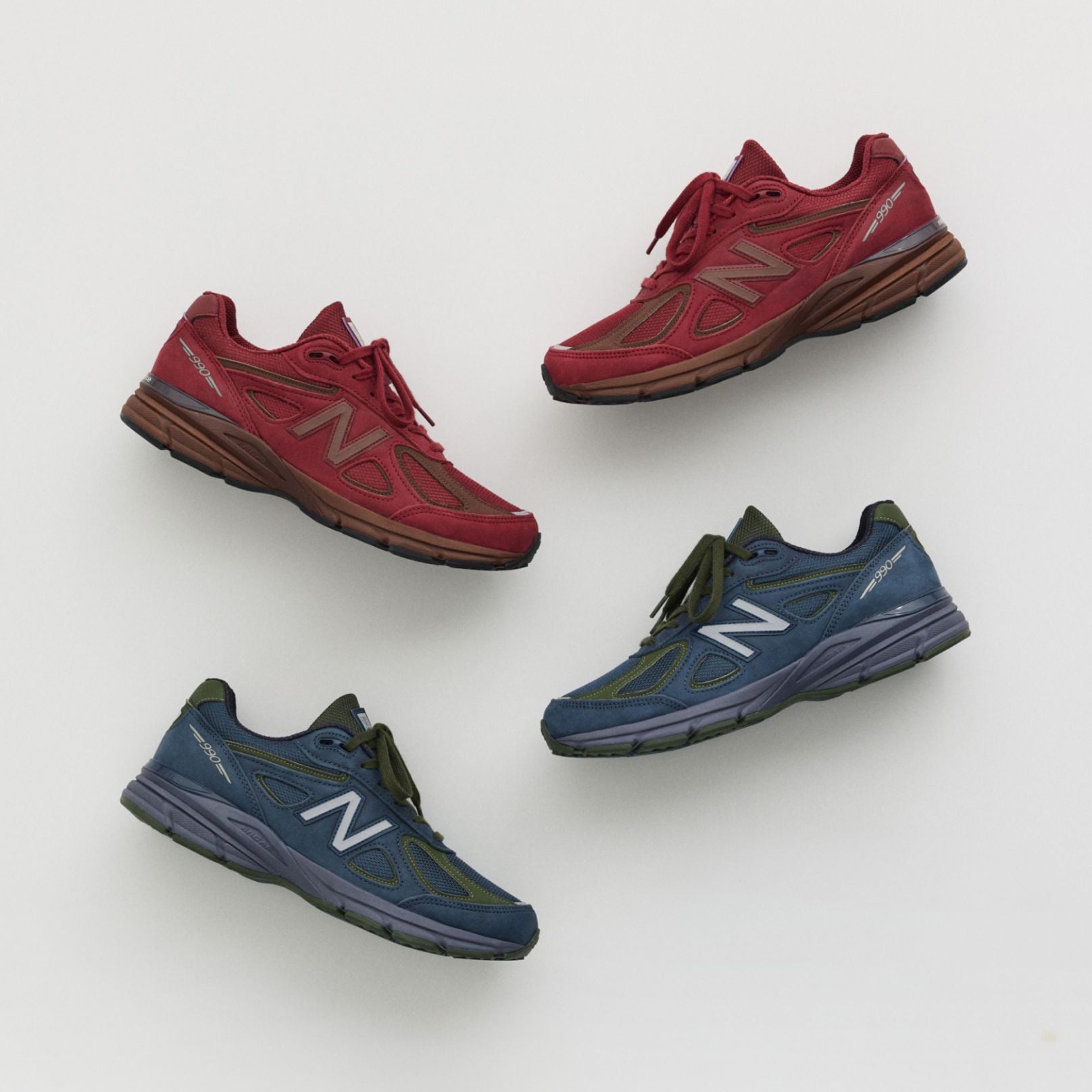 A maroon and navy shoe laying on a grey studio backdrop. 