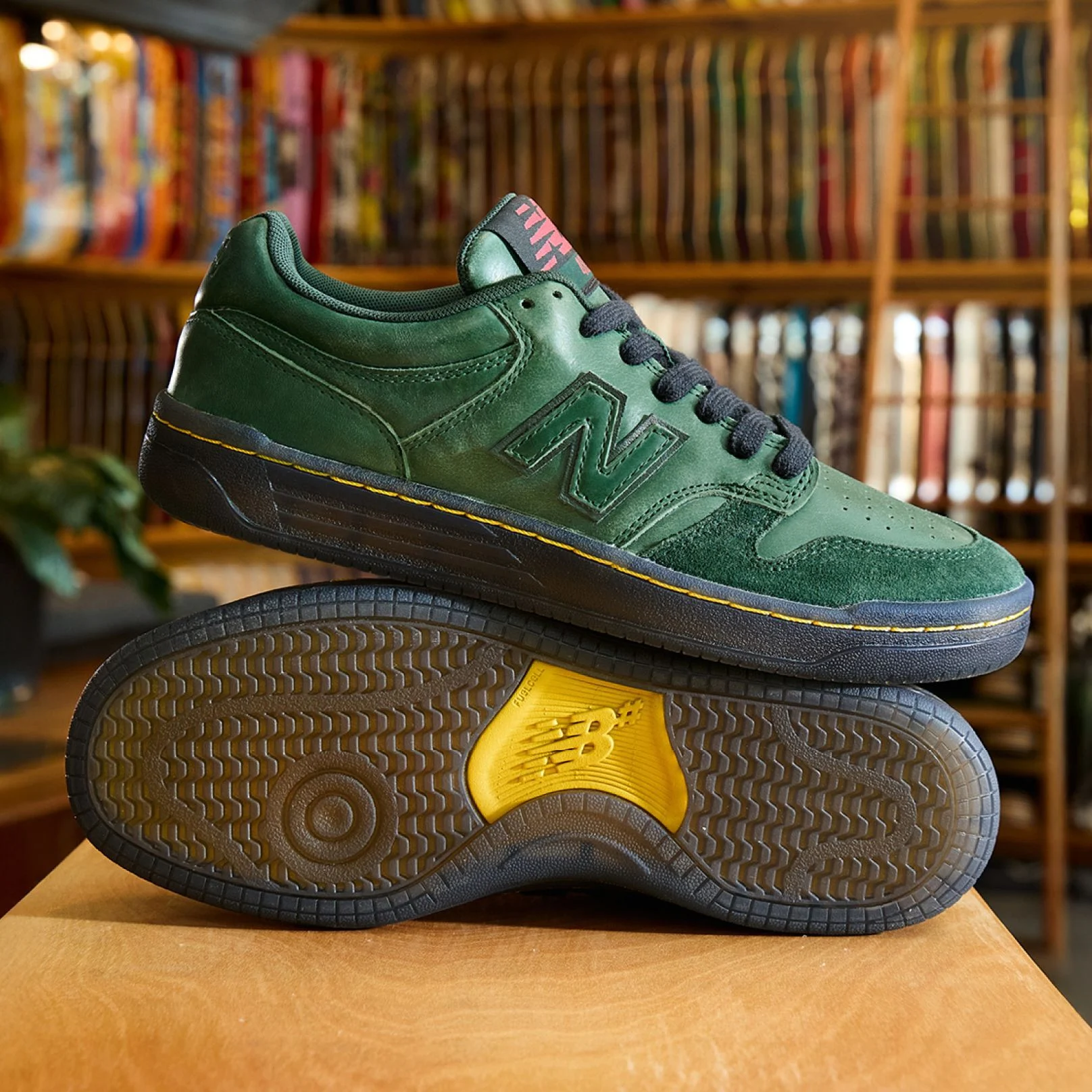 A pair of green 480 shoes in a skate shop.